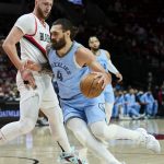 
              Memphis Grizzlies center Steven Adams, right, dribbles around Portland Trail Blazers center Jusuf Nurkic during the first half of an NBA basketball game in Portland, Ore., Wednesday, Dec. 15, 2021. (AP Photo/Craig Mitchelldyer)
            