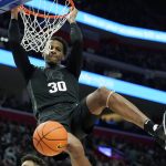 
              Michigan State forward Marcus Bingham Jr. dunks during the second half of an NCAA college basketball game against Oakland , Tuesday, Dec. 21, 2021, in Detroit. (AP Photo/Carlos Osorio)
            