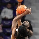 
              Kansas State's Kaosi Ezeagu, back, blocks a shot by Albany's Aaron Reddish (10) during the first half of an NCAA college basketball game Wednesday, Dec. 1, 2021, in Manhattan, Kan. (AP Photo/Charlie Riedel)
            