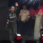 
              Mercedes driver Lewis Hamilton of Britain waves from the podium after winning the Formula One Saudi Arabian Grand Prix in Jiddah, Sunday, Dec. 5, 2021. (AP Photo/Hassan Ammar)
            