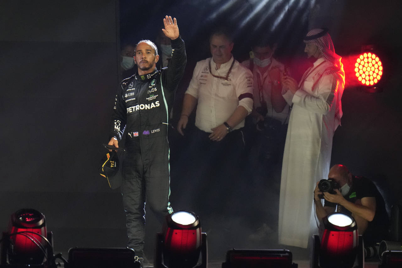 Mercedes driver Lewis Hamilton of Britain waves from the podium after winning the Formula One Saudi...