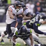 
              Chicago Bears running back David Montgomery carries against the Seattle Seahawks during the second half of an NFL football game, Sunday, Dec. 26, 2021, in Seattle. (AP Photo/Stephen Brashear)
            