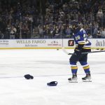 
              St. Louis Blues' Nathan Walker (26) skates past hats on the ice after scoring his third goal of the night, during the third period in the team's NHL hockey game against the Detroit Red Wings on Thursday, Dec. 9, 2021, in St. Louis. (AP Photo/Scott Kane)
            