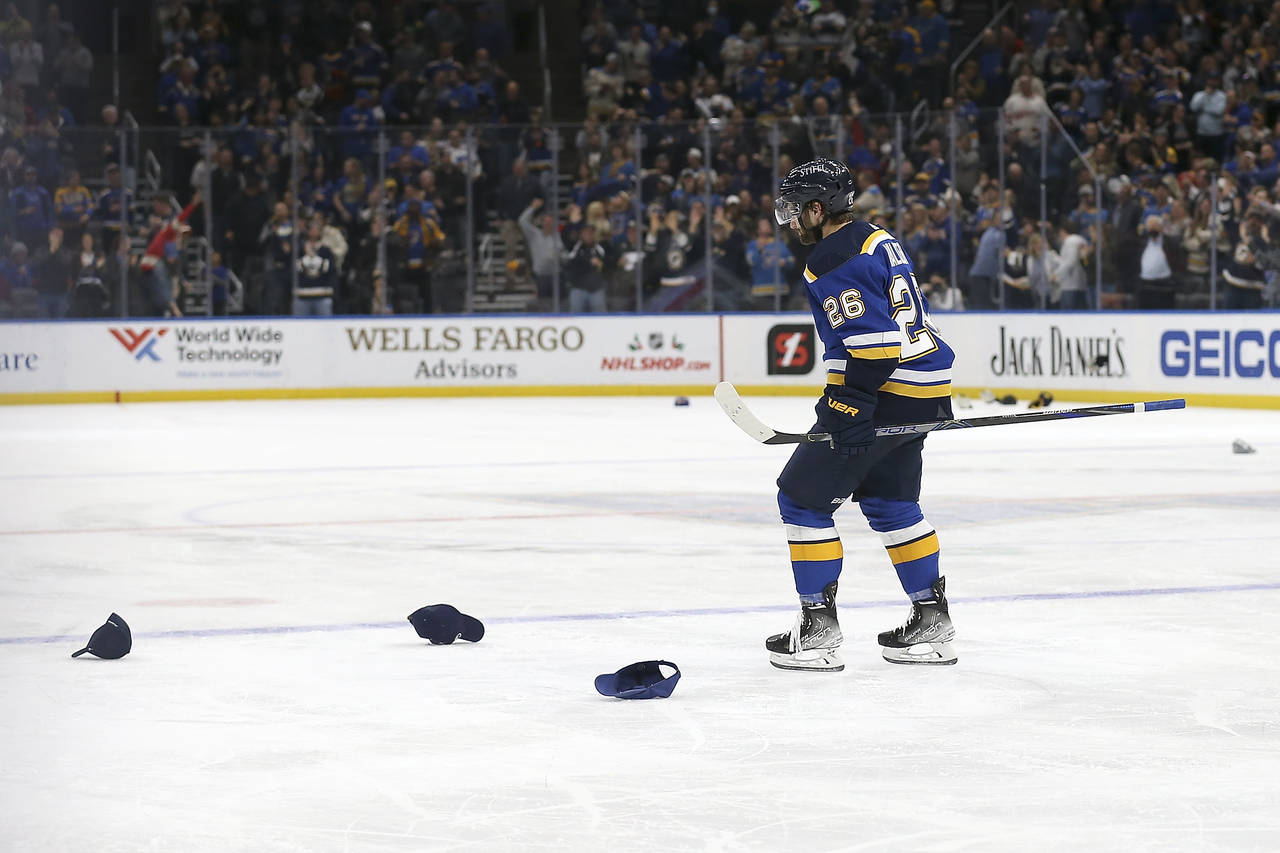St. Louis Blues' Nathan Walker (26) skates past hats on the ice after scoring his third goal of the...