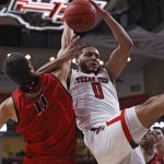 
              Eastern Washington's Rylan Bergersen (11) fouls Texas Tech's Kevin Obanor (0) while rebounding the ball during the first half of an NCAA college basketball game on Wednesday, Dec. 22, 2021, in Lubbock, Texas. (AP Photo/Brad Tollefson)
            