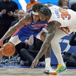 
              Detroit Pistons forward Saddiq Bey (41) and New York Knicks forward Julius Randle (30) reach for a loose ball during the second half of an NBA basketball game, Wednesday, Dec. 29, 2021, in Detroit. (AP Photo/Carlos Osorio)
            