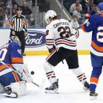 
              New York Islanders goaltender Semyon Varlamov (40) blocks a shot by Chicago Blackhawks center Ryan Carpenter (22) during the first period of an NHL hockey game, Sunday, Dec. 5, 2021, in Elmont, N.Y. (AP Photo/Corey Sipkin).
            