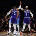 
              Los Angeles Lakers guard Russell Westbrook (0) high-fives forward Carmelo Anthony (7) during the first half of an NBA basketball game against the Los Angeles Clippers in Los Angeles, Friday, Dec. 3, 2021. (AP Photo/Ashley Landis)
            