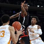 
              Tennessee guard Kennedy Chandler, right, passes around Texas Tech forward Bryson Williams (11) to Olivier Nkamhoua (13) during the first half of an NCAA college basketball game in the Jimmy V Classic on Tuesday, Dec. 7, 2021, in New York. (AP Photo/Adam Hunger)
            