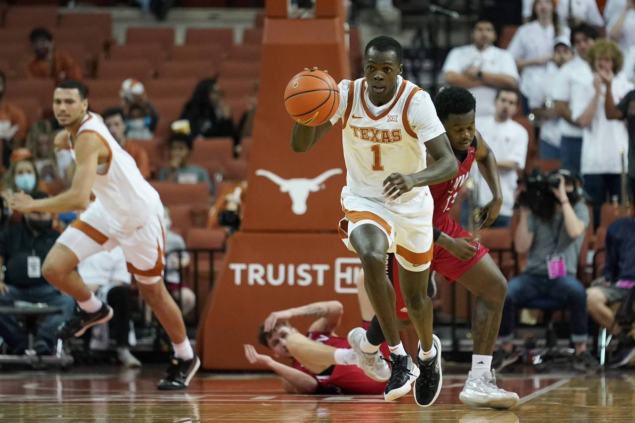 Texas guard Andrew Jones (1) moves the ball up court against Incarnate Word after a steal during th...