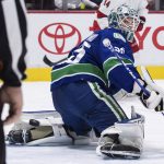 
              Vancouver Canucks goalie Thatcher Demko watches as the puck bounces off the post behind him and stays out of the net during the second period of an NHL hockey game against the Carolina Hurricanes in Vancouver, British Columbia, Sunday, Dec. 12, 2021. (Darryl Dyck/The Canadian Press via AP)
            