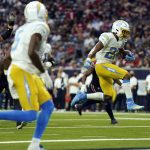 
              Los Angeles Chargers running back Justin Jackson (22) leaps into the end zone for a touchdown during the second half of an NFL football game against the Houston Texans Sunday, Dec. 26, 2021, in Houston. (AP Photo/Eric Christian Smith)
            
