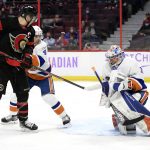 
              Ottawa Senators left wing Brady Tkachuk (7) and New York Islanders defenceman Andy Greene (4) watch as goaltender Ilya Sorokin (30) tries to control the puck during the second period of an NHL hockey game Tuesday, Dec. 7, 2021, in Ottawa, Ontario. (Justin Tang/The Canadian Press via AP)
            