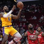
              Los Angeles Lakers forward LeBron James (6) shoots as Houston Rockets forward David Nwaba, middle, defends during the first half of an NBA basketball game Tuesday, Dec. 28, 2021, in Houston. (AP Photo/Eric Christian Smith)
            