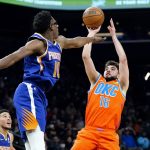 
              Oklahoma City Thunder guard Ty Jerome (16) shoots over Phoenix Suns forward Jalen Smith (10) during the first half of an NBA basketball game Wednesday, Dec. 29, 2021, in Phoenix. (AP Photo/Ross D. Franklin)
            
