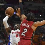 
              Detroit Pistons guard Hamidou Diallo (6) goes up for a shot over Miami Heat guard Gabe Vincent (2) during the first half of an NBA basketball game, Thursday, Dec. 23, 2021, in Miami. (AP Photo/Jim Rassol)
            