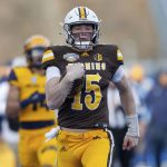 
              Wyoming quarterback Levi Williams (15) runs down the sidelines on a 50 yard touchdown run against Kent State during the first half of the Idaho Potato Bowl NCAA college football game, Tuesday, Dec. 21, 2021, in Boise, Idaho. (AP Photo/Steve Conner)
            