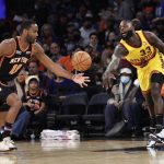
              New York Knicks guard Alec Burks (18) grabs a loose ball in front of Atlanta Hawks guard Lance Stephenson (33) during the first half of an NBA basketball game Saturday, Dec. 25, 2021, in New York. (AP Photo/Adam Hunger)
            
