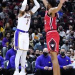 
              Los Angeles Lakers forward Carmelo Anthony, left, shoots over Chicago Bulls center Tony Bradley during the first half of an NBA basketball game in Chicago, Sunday, Dec. 19, 2021. (AP Photo/Nam Y. Huh)
            