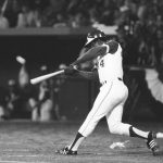 
              FILE - Atlanta Braves' Hank Aaron hits his 715th career home run in Atlanta Stadium, April 8, 1974, to break the all-time record set by the late Babe Ruth. The ball is a blur as it leaves the bat. Aaron made history with one swing of his bat. A year later and on the other side of Georgia, Lee Elder made history with one swing of his driver. Their deaths in 2021 were mourned beyond the sports world and were reminders of the hate, hardships and obstacles they endured with dignity on their way to breaking records and barriers. (AP Photo/Joe Holloway, Jr., File)
            