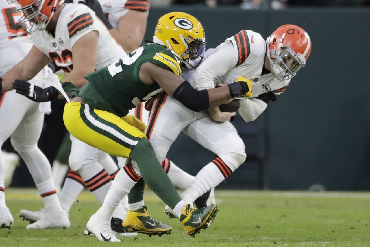 Green Bay Packers' Rashan Gary sacks Cleveland Browns' Baker Mayfield during the first half of an N...