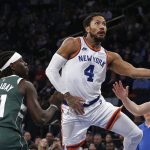 
              New York Knicks guard Derrick Rose (4) drives to the basket against Milwaukee Bucks guard Jrue Holiday (21) during the first half of an NBA basketball game in New York, Sunday, Dec. 12, 2021. (AP Photo/Noah K. Murray)
            