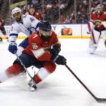 
              Tampa Bay Lightning left wing Pierre-Edouard Bellemare (41) and Florida Panthers defenseman Radko Gudas (7) go for the puck during the first period of an NHL hockey game, Thursday, Dec. 30, 2021, in Sunrise, Fla. (AP Photo/Lynne Sladky)
            