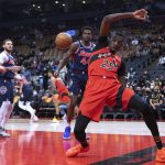 
              Toronto Raptors' Chris Boucher regains his balance after scoring against the Philadelphia 76ers during the first half of an NBA basketball game Tuesday, Dec. 28, 2021, in Toronto. (Chris Young/The Canadian Press via AP)
            