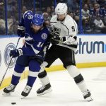 
              Los Angeles Kings right wing Adrian Kempe (9) knocks Tampa Bay Lightning left wing Pat Maroon (14) off the puck during the second period of an NHL hockey game Tuesday, Dec. 14, 2021, in Tampa, Fla. (AP Photo/Chris O'Meara)
            