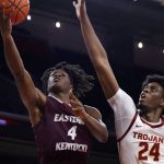 
              Eastern Kentucky guard Curt Lewis (4) goes to basket while defended by Southern California forward Joshua Morgan (24) during the second half of an NCAA college basketball game Tuesday, Dec. 7, 2021, in Los Angeles. USC won 80-68. (AP Photo/Ringo H.W. Chiu)
            