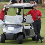 
              Tiger Woods stands with his cart on the third fairway during the second round of the PNC Championship golf tournament Sunday, Dec. 19, 2021, in Orlando, Fla. (AP Photo/Scott Audette)
            