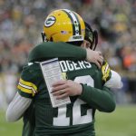 
              Green Bay Packers' Aaron Rodgers is congratulated by offensive coordinator Nathaniel Hackett after throwing career touchdown pass 443 during the first half of an NFL football game against the Cleveland Browns Saturday, Dec. 25, 2021, in Green Bay, Wis. The pass breaks the previous Green Bay Packers record held by Brett Favre.(AP Photo/Aaron Gash)
            