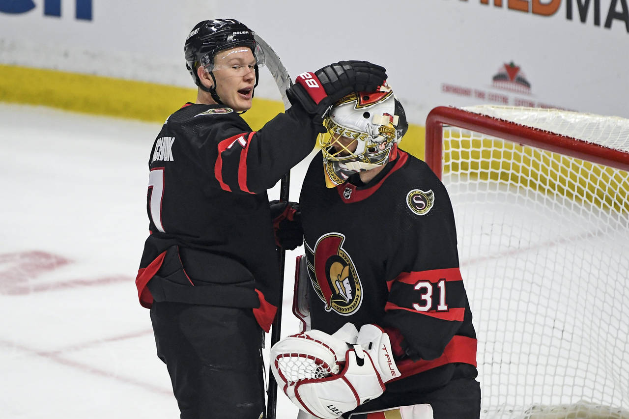 Ottawa Senators left wing Brady Tkachuk (7) and goalie Anton Forsberg (31) celebrate after defeatin...