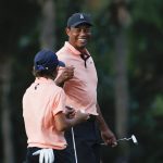 
              Tiger Woods reacts with his son Charlie Woods on the 16th green during the first round of the PNC Championship golf tournament Saturday, Dec. 18, 2021, in Orlando, Fla. (AP Photo/Scott Audette)
            