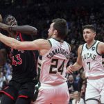 
              Toronto Raptors' Pascal Siakam, left, tries to shoot as Milwaukee Bucks' Pat Connaughton, center, defends Grayson Allen watches during the second half of an NBA basketball game Thursday, Dec. 2, 2021, in Toronto. (Chris Young/The Canadian Press via AP)
            