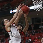 
              Texas Tech's Clarence Nadolny (3) and Eastern Washington's Michael Folarin (23) try to rebound the ball during the second half of an NCAA college basketball game on Wednesday, Dec. 22, 2021, in Lubbock, Texas. (AP Photo/Brad Tollefson)
            