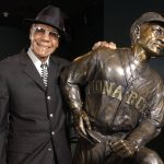 
              FILE - In this Feb. 11, 2005, file photo, Buck O'Neil stands with a statue of himself in the Negro League Baseball Museum in Kansas City, Mo. O’Neil, a champion of Black ballplayers during a monumental, eight-decade career on and off the field, has joined Gil Hodges, Minnie Minoso and three others in being elected to the baseball Hall of Fame, on Sunday, Dec. 5, 2021. (AP Photo/Charlie Riedel, File)
            