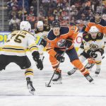 
              Edmonton Oilers' Jesse Puljujarvi (13) brings the puck up against Boston Bruins' Connor Clifton (75) as Bruins'Taylor Hall (71) pursues during second-period NHL hockey game action in Edmonton, Alberta, Thursday, Dec. 9, 2021. (Amber Bracken/The Canadian Press via AP)
            