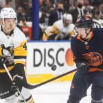 
              Pittsburgh Penguins' Danton Heinen (43) and Edmonton Oilers' Kailer Yamamoto (56) vie for the puck during the first period of an NHL hockey game Wednesday, Dec 1, 2021, in Edmonton, Alberta. (Jason Franson/The Canadian Press via AP)
            
