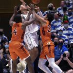 
              Duke's Paolo Banchero (5) loses the ball while Virginia Tech's Nahiem Alleyne (4) and Keve Aluma (22) defend during the first half of an NCAA college basketball game in Durham, N.C., Wednesday, Dec. 22, 2021. (AP Photo/Ben McKeown)
            