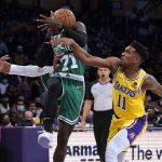 
              Boston Celtics guard Dennis Schröder (71) is defended by Los Angeles Lakers guard Malik Monk (11) and forward Carmelo Anthony (7) during the first half of an NBA basketball game Tuesday, Dec. 7, 2021, in Los Angeles. (AP Photo/Marcio Jose Sanchez)
            