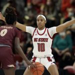 
              North Carolina State guard Aziaha James (10) guards Elon guard Brie Perpignan (0) during the first half of an NCAA college basketball game in Raleigh, N.C., Sunday, Dec. 5, 2021. (AP Photo/Gerry Broome)
            