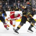 
              Vegas Golden Knights left wing William Carrier (28) skates with the puck while followed by Calgary Flames defenseman Christopher Tanev (8) and Golden Knights right wing Keegan Kolesar (55) during the second period of an NHL hockey game Sunday, Dec. 5, 2021, in Las Vegas. (AP Photo/Ellen Schmidt)
            