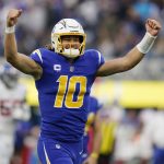 
              Los Angeles Chargers quarterback Justin Herbert celebrates after throwing a pass to wide receiver Jalen Guyton during the first half of an NFL football game Sunday, Dec. 12, 2021, in Inglewood, Calif. (AP Photo/Gregory Bull)
            