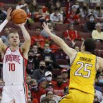 
              Ohio State's Justin Ahrens, left, shoots over Towson's Nicolas Timberlake during the second half of an NCAA college basketball game Wednesday, Dec. 8, 2021, in Columbus, Ohio. (AP Photo/Jay LaPrete)
            