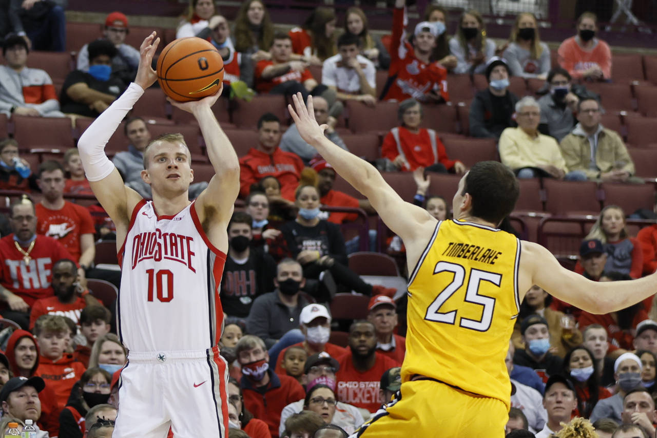 Ohio State's Justin Ahrens, left, shoots over Towson's Nicolas Timberlake during the second half of...