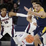 
              Gonzaga guard Hunter Sallis, left, and Northern Arizona guard Jay Green go after the ball during the first half of an NCAA college basketball game, Monday, Dec. 20, 2021, in Spokane, Wash. (AP Photo/Young Kwak)
            