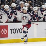 
              Columbus Blue Jackets center Max Domi celebrates with teammates on the bench after scoring a goal during the second period of an NHL hockey game against the Seattle Kraken, Saturday, Dec. 11, 2021, in Seattle. (AP Photo/Stephen Brashear)
            