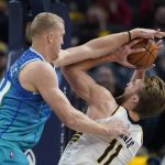 
              Indiana Pacers' Domantas Sabonis (11) is fouled by Charlotte Hornets' Mason Plumlee (24) as he goes up for a shot during the first half of an NBA basketball game, Wednesday, Dec. 29, 2021, in Indianapolis. (AP Photo/Darron Cummings)
            