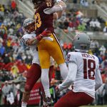 Central Michigan tight end Joel Wilson (83) catches a pass in the end zone for a touchdown against the defense of Washington State linebacker Justus Rogers (37) during the first half of the Sun Bowl NCAA college football game in El Paso, Texas, Friday, Dec. 31, 2021. (AP Photo/Andres Leighton)